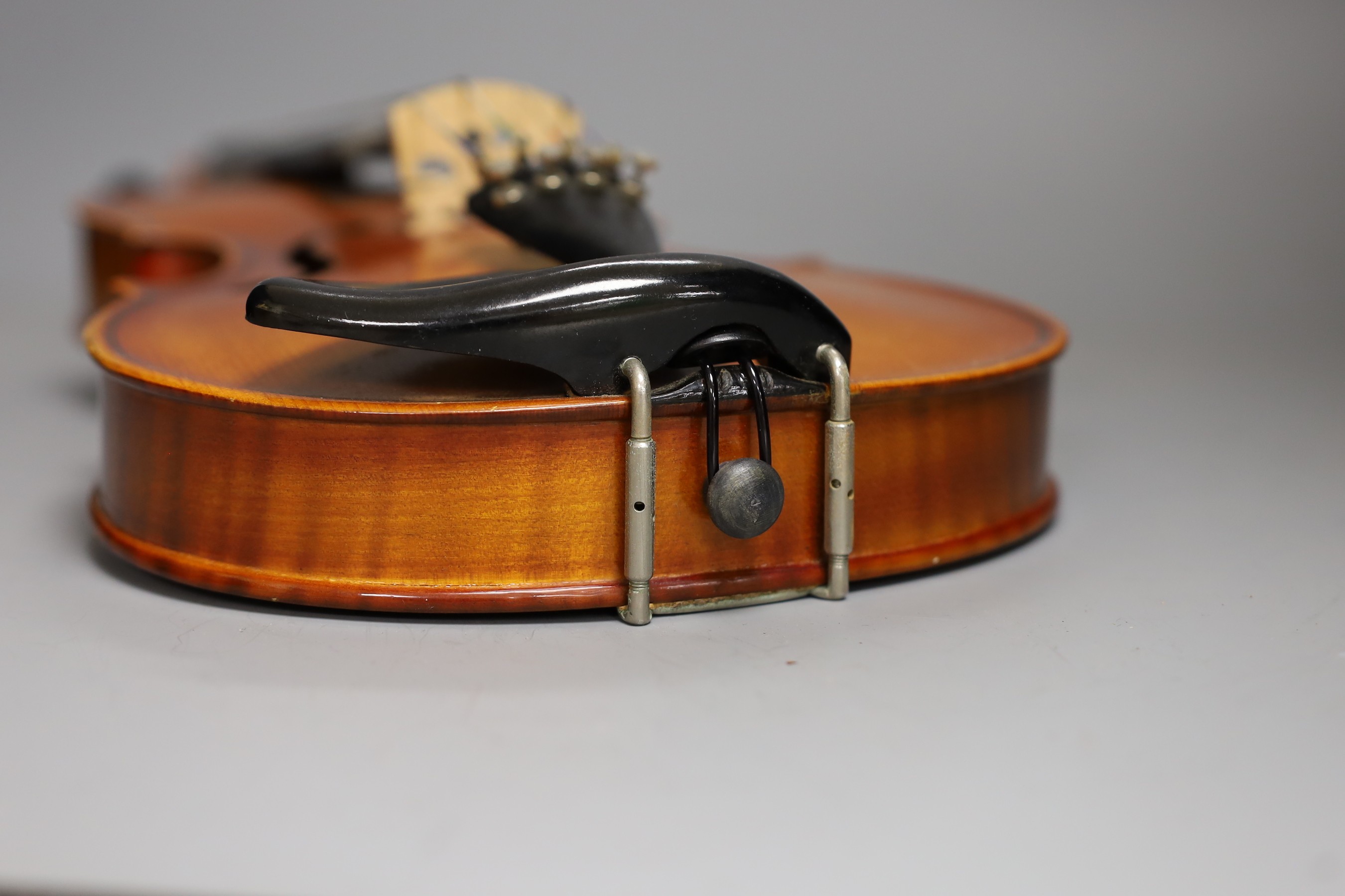 A cased child's violin and bow with ivorine tip, violin 55cms long